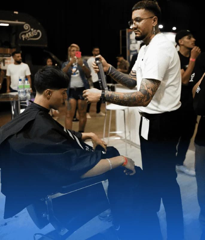 Barbero trabajando durante evento, imagen de testimonio sobre el impacto de Weibook en barberías